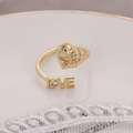 Gold-plated adjustable ring featuring a heart motif, LOVE lettering, and sparkling cubic zirconia - Gold