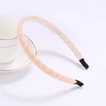 Detail of woven beaded headband in cream pink pearl texture on a white porcelain cup - Nude