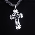 Macro shot of a gothic silver cross pendant with black inlay on a heavy metal chain - Retro Cross Byzantine Chain
