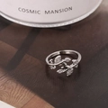 Elegant silver leaf ring with cubic zirconia stones on a brown magazine background - Silver Style (D7206)