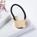 Detail of a minimalist gold metal hair cuff with a black elastic tie on white stone - U-Shaped Style (H7104) / U-Shaped Gold Color