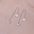 Detail view of long silver chain earrings with white pearls and hollow butterfly charms - Polished Butterfly Silver A2438