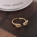 Elegant gold wing-shaped open ring with cubic zirconia stones in a luxury setting - Gold