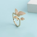 Detail of gold-plated butterfly ring featuring micro-pave cubic zirconia on blue background - Gold