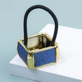 Macro shot of golden square hair tie clip with blue glitter inlay and black elastic band - Blue