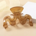 Elegant amber translucent wavy hair claw clip with minimalist resin wave design - Caramel color