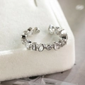 Macro view of a silver-tone adjustable ring with multi-shape cubic zirconia in a jewelry box - Silver L2403