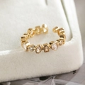 Macro detail of gold-plated copper ring featuring sparkling multi-shape zircon stones - Gold D7426