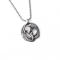 Close-up of vintage stainless steel raven head pendant with detailed feather relief - Eagle Beak Style