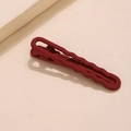 Detail of red matte wave hair clip with a stylish textured finish on a beige background - Deep Red (E2224)