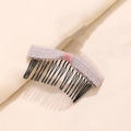 Detail of pink lace bow hair comb with wavy metal teeth for elegant styling - Pink