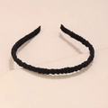 Detailed close-up of a black pleated fabric headband showing soft texture and elastic design - Black