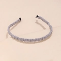 Close-up of light grey pleated fabric headband with fine accordion texture detail - Gray