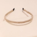 Detail of pleated fabric headband in beige showing smooth texture and protective black ends - Khaki
