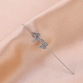 Detail of silver butterfly ear crawler with rhinestones on champagne silk background - Butterfly Style Silver