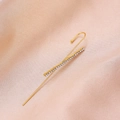 Detail view of a golden lightning-shaped ear crawler with white rhinestones on pink silk - Criss-Cross Gold