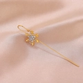 Detailed macro shot of gold snowflake ear crawler earring with sparkling cubic zirconia - Snowflake Gold