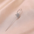 Detail of silver snowflake ear cuff with sparkling zircon inlay on champagne silk background - Snowflake Silver