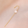 Detail of minimalist gold pearl hook earring on soft pink silk background - Pearl Gold