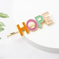 Macro detail of alloy hair clip with HOPE letter design in colorful drip oil finish - HOPE Word Style (C5403)