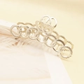 Detailed view of matte silver hair claw clip with twisted texture and ring design - Silver