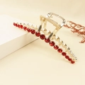 Detail of a golden metal hair claw clip set with elegant red round rhinestones - Red (E8423)