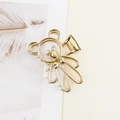 Detail shot of golden bear claw clip featuring crystal eyes and hollow metal texture - Gold Panda with White Eye