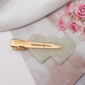 Detail of double heart resin hair clip with pearlescent finish and gold metal base - Green