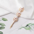 Elegant floral bobby pin with white pearls and purple rhinestones on a golden base - Gold