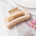 Close-up of large rectangular hollow hair claw clip in elegant jelly beige finish - Light Pink