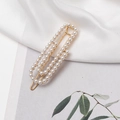 Detailed close-up of a French style pearl hair clip on an elegant white silk background - Gold (E3411)