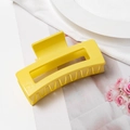 Detail of a large bright yellow hollow square hair claw clip for thick hair styling - Yellow