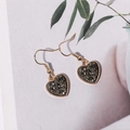 Detailed view of heart-shaped gold earrings with textured dark grey druzy stone inlay - Dark Gray (E6213)