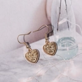 Detail shot of heart-shaped drop earrings with golden resin texture and metal hooks - Earthy Yellow (E6215)