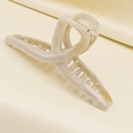 Detail of cream marble hair claw clip with golden metal spring on silk background - Off White