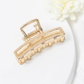 Macro detail of golden rectangular hollow hair claw clip with sturdy metal spring - Rectangular Style (E1130)