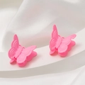 Dettaglio di due mollette a farfalla rosa acceso con finitura opaca su supporto bianco - Rosa