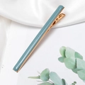 Detail shot of pale green enamel hair clip with gold alloy base and serrated grip - Dark Blue