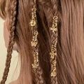 Close-up of golden spiral hair clips with charms on braided hair for styling - Vintage Insect Floral Pendant Style (E7530)