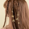 Detail of gold spiral hair rings with butterfly and dragonfly charms on braided hair - Vintage Butterfly Dragonfly Pendant Style (E7527)