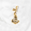 Detail of a vintage golden anchor pendant hair clip with spiral ring on textured white fabric - Anchor Charm (M5120)