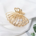 Detail of a gold metal hair claw with shell shape design and pearl embellishments - Shell Pearl Style (C5336)