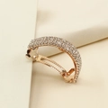 Close-up of golden spring hair clip with four rows of sparkling white rhinestones - Rose Gold