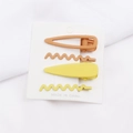 Detailed view of matte yellow and orange metal geometric wave hair clips set on a card - Geometric Strip and Wave Style (B4402) / Yellow Orange Series (B4402)