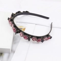Detail of black braided headband featuring pink rhinestone flowers and styling hair clips - Pink (E6131)