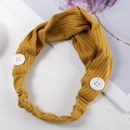 Close-up of yellow ribbed knit headband with buttons and twist knot design detail - Ginger Yellow
