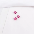 Detailed macro view of three rose pink hollow crown-shaped aluminum dreadlock beads - Rose Red