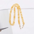 Detailed macro view of leopard amber acrylic glasses chain with gold lobster clasp - Amber Cream (K3405)
