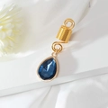 Detailed view of golden spiral hair coil with pear-cut blue crystal pendant for braids - Deep Blue (E8422)
