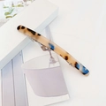 Macro detail of tortoiseshell acetate hair clip with premium blue and brown textures - Dark Leopard Print